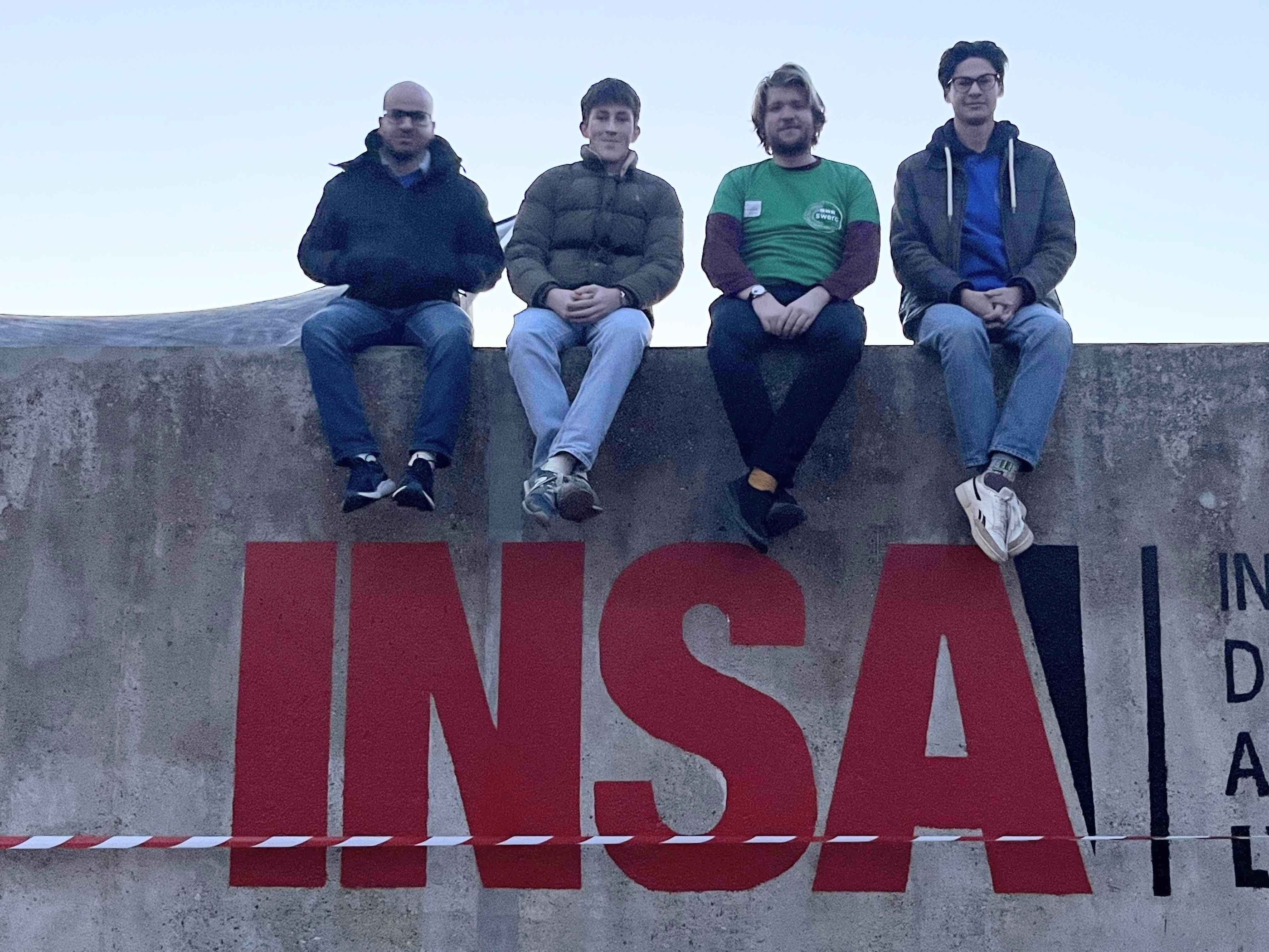 Team photo on the INSA wall with from left to right: Ahmed, Jules, Mathis and myself